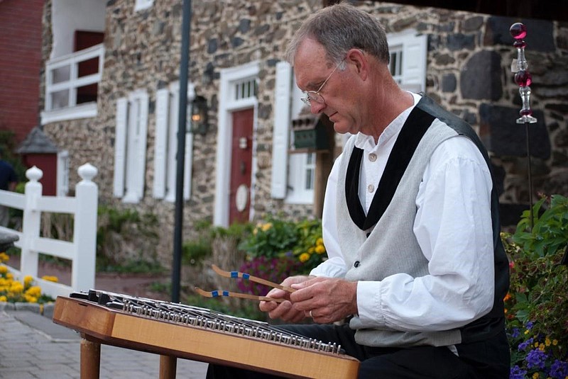 Tom Jolin, playing a 17th century dulcimer. 