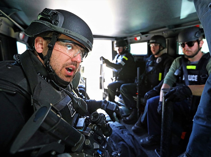 SWAT trainees inside of an armored vehicle preparing to approach the training site. 