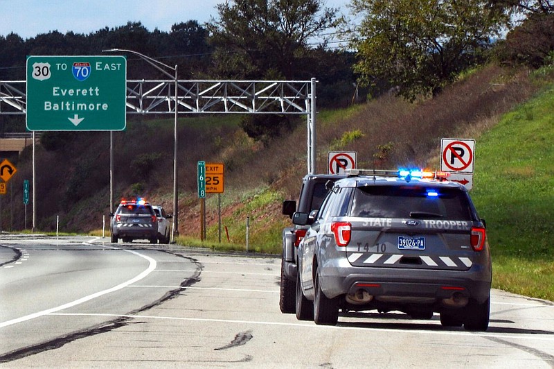 Pennsylvania State troopers pull over vehicles on Friday, Sept. 4, 2020, along the Pennsylvania Turnpike in Breezewood, Pa. 