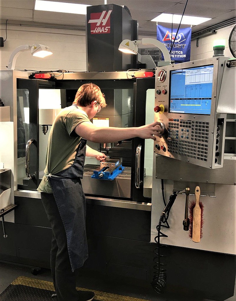 A student at North Montco Technical Career Center training on a CNC machine. 