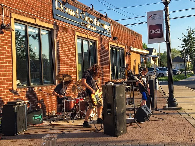 Big Handsome performs outside of Round Guys. 