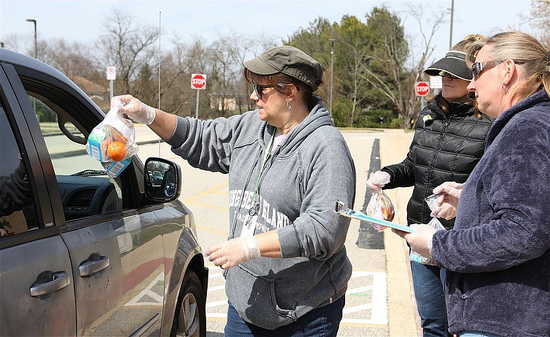 Volunteers distribute food on March 17, 2020. 