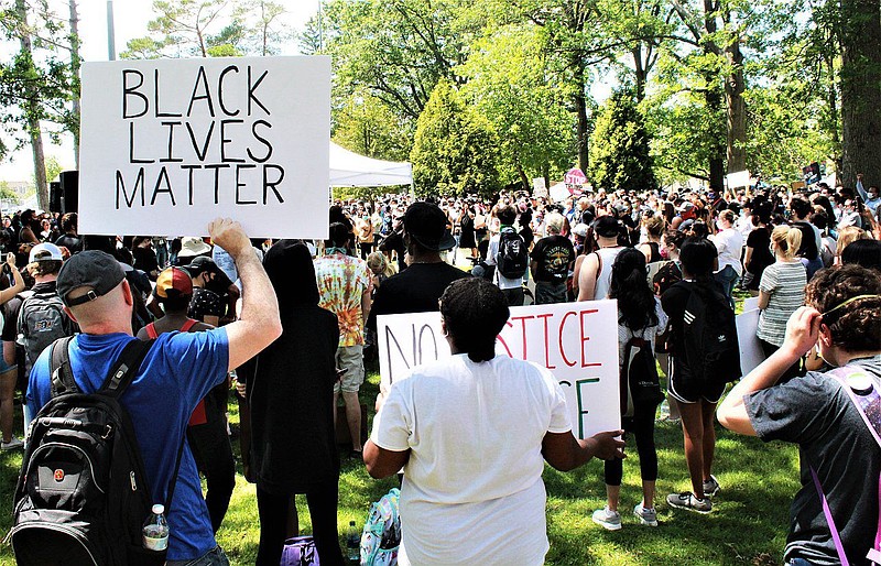 A demonstrator holds a Black Lives Matter sign during a solidarity rally at Memorial Park in Lansdale on June 7. 