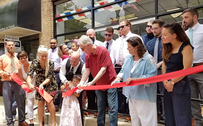 Owner Nicky Prosseda helps daughter Concetta cut the ribbon 