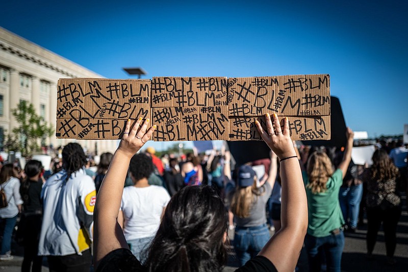 A protestor in Des Moines, Iowa holds up a Black Lives Matter sign. 