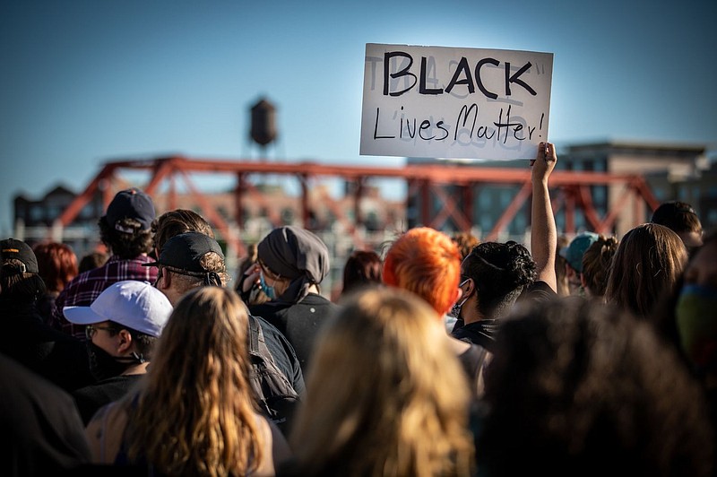 A protestor in Des Moines, Iowa holds up a Black Lives Matter sign. 