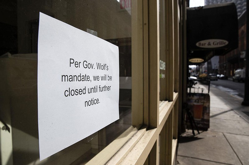 A sign is posted in the window of a closed business in Philadelphia, Friday, March 20, 2020. Pennsylvania Gov. Tom Wolf directed all "non-life-sustain