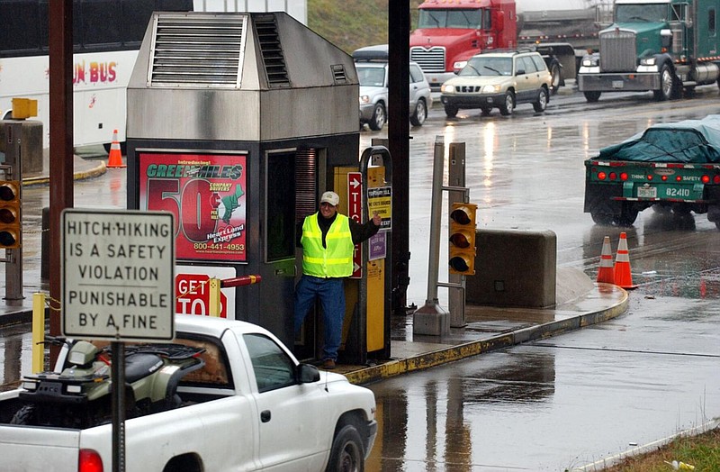 A toll worker gives a motorist a thumbs-up after waving their vehicle past a ticket booth in Carlisle, Pa. The Pennsylvania Turnpike Commission announ