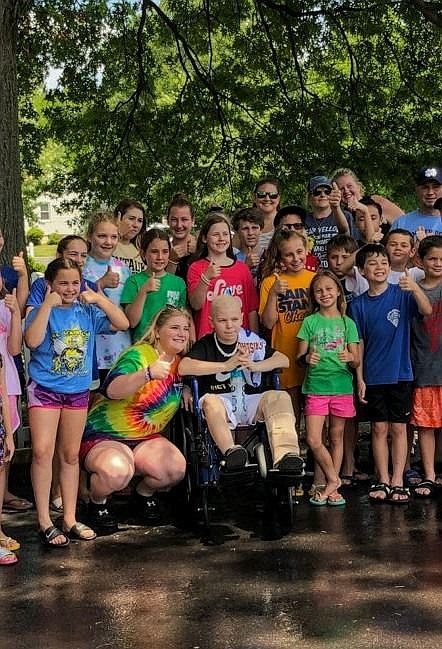 Volunteers from the Mater Dei CYO surround Will Albright for a group photo. 