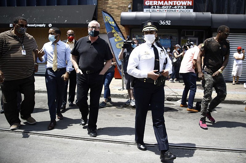 Philadelphia Police Commissioner Danielle Outlaw, center, and Mayor Jim Kenney, 4th left, meet with people, Thursday, June 4, 2020, in Philadelphia af