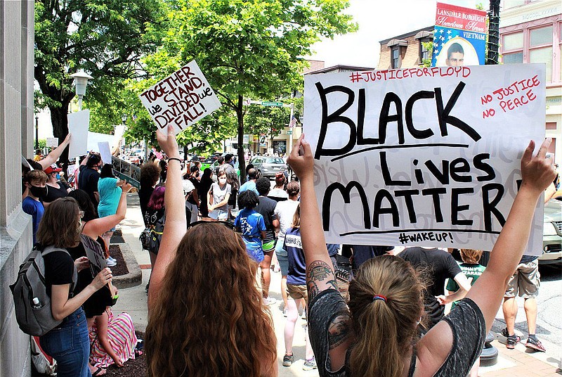 A protester holds up a Black Lives Matter sign during a demonstration on Main Street in Lansdale on June 20. 