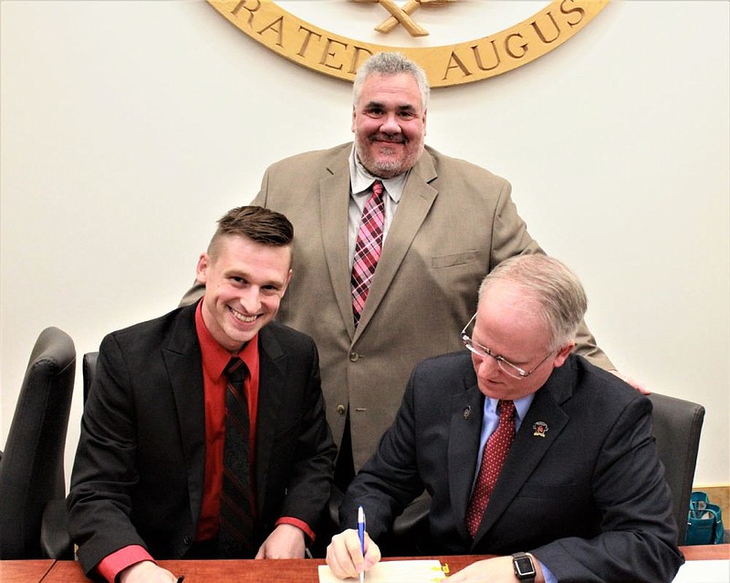 Lansdale Borough Mayor Garry Herbert (left) with Councilman Leon Angelichio (center) as Council President Denton Burnell (right) signs the Human Relat