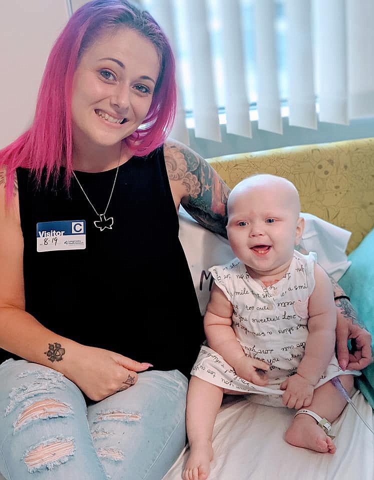 Tell-Tale Art Studios owner Amanda Roberts, left, visiting Dakota Ann, right, in the hospital. 