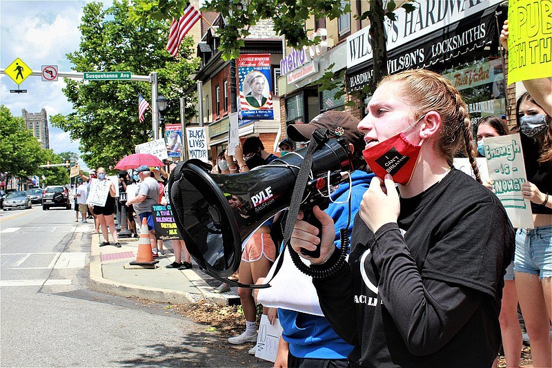 Melanie Hartnett, organizer of the demonstration, addresses a crowd of protesters on West Main Street in Lansdale on June 20. 