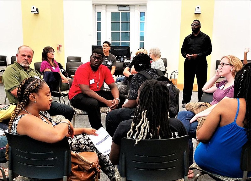 Anwar Muhammad addresses the group at the fourth racism forum. 