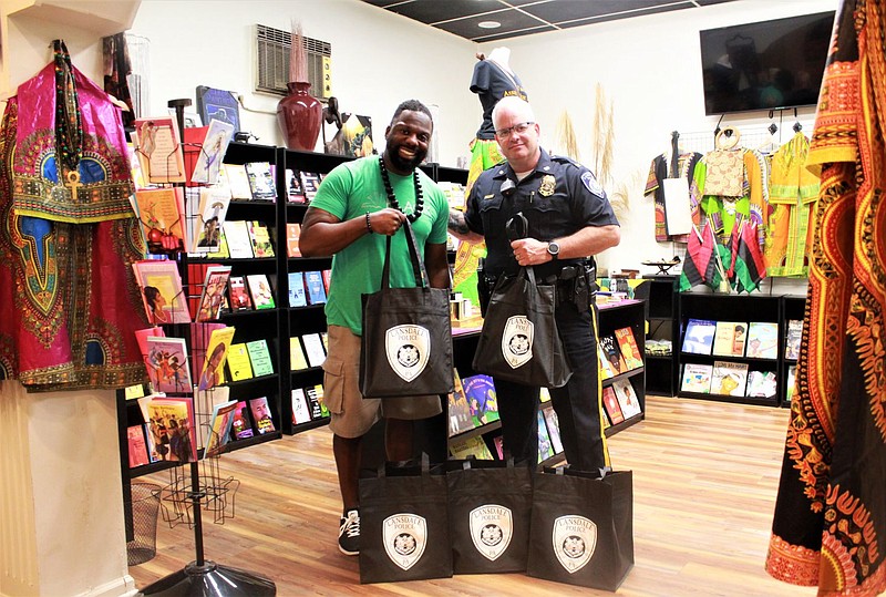 Black Reserve Bookstore owner Shaykh Anwar Muhammad, left, with Lansdale Borough Police Chief Michael Trail, right. 