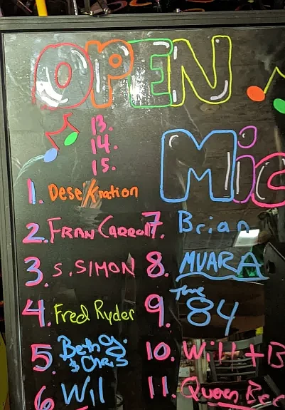 Artists sign up on a board to perform during Open Mic night at High Steaks in Ambler. (Credit: Kathy Disque)