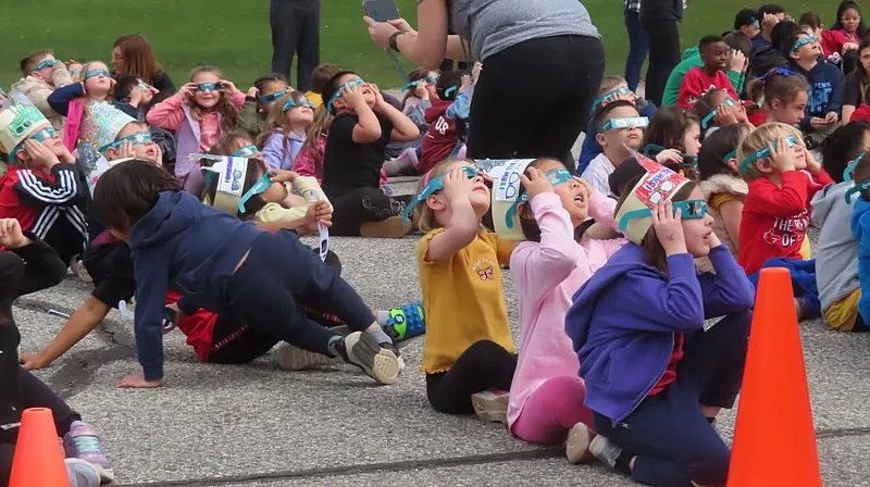 Students at Gwynedd Square Elementary School in Upper Gwynedd wear solar eclipse glasses provided by Merck to watch the solar eclipse on Monday, April 8 2024. (Dan Sokil – MediaNews Group)