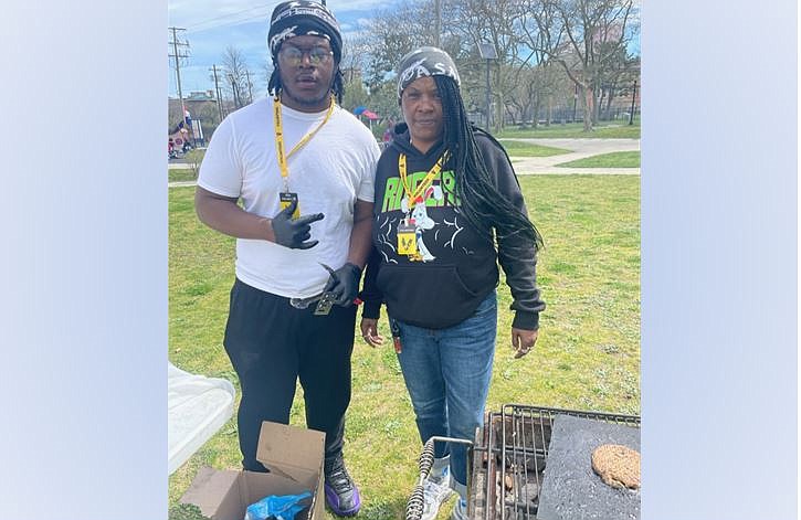 Buddie Allen, left, operated the grill while his mother, Tia Allen, contributed bags of clothes and shoes, and cooked a huge amount of food.
