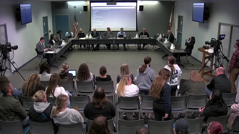 Pennbrook Middle School students, standing in crowd, address the North Penn school board with questions about an alleged attack on a student at Pennbrook during the school board meeting on April 18, 2024. (Screenshot of NPTV video)