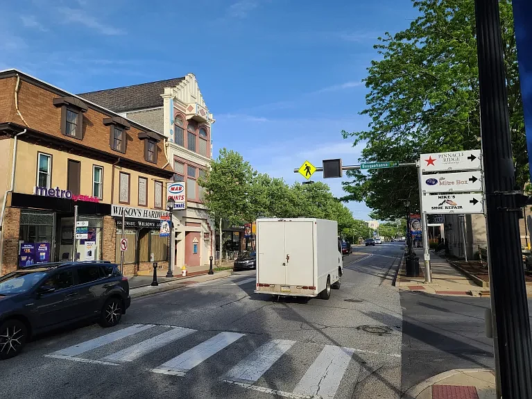 Cars drive past new business wayfinding signs on Main Street at Susquehanna Avenue in Lansdale on Wednesday, May 8 2024.