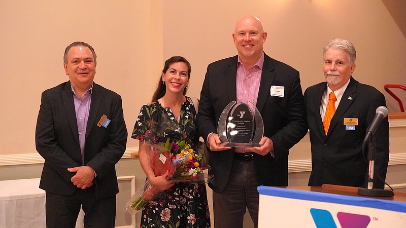 Aaron Bibro and his wife Rebecca with North Penn YMCA CEO Bob Gallagher, left, and Board President Howard Reid, right.