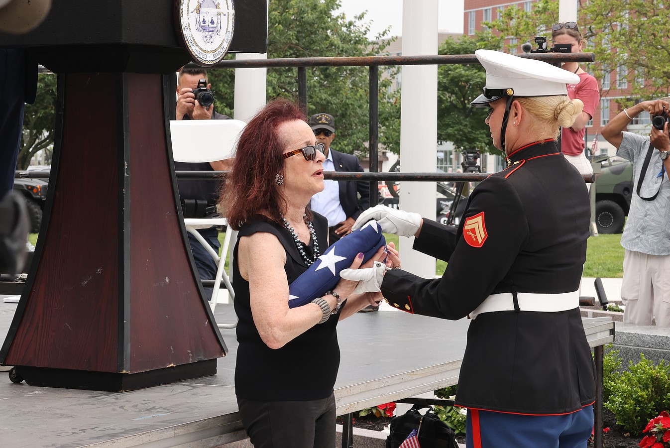 Susan Friedenberg accepts the flag honoring her father.