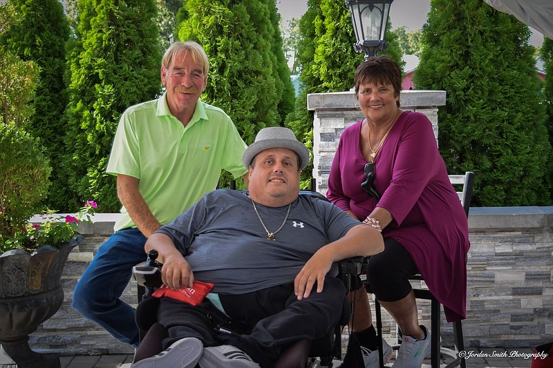 Darryl Behnke is joined by his mother, Debbie Behnke, and her husband, Charles Hassler, during Darryl’s 42nd birthday in 2023. (Photo courtesy of Debbie Behnke)