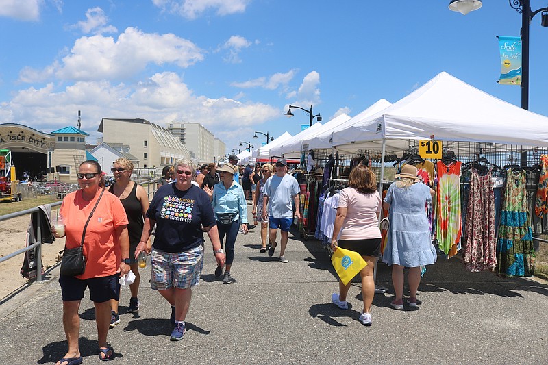 The oceanfront Promenade is crowded with shoppers at the tent-covered vendor booths.