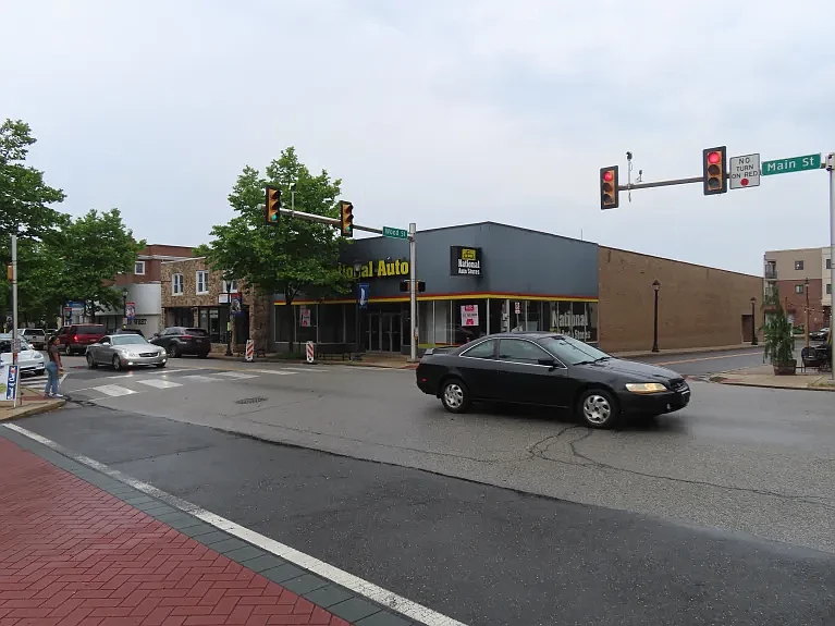 Cars drive past the vacant National Auto building at Main and Wood Streets in Lansdale in June 2022.