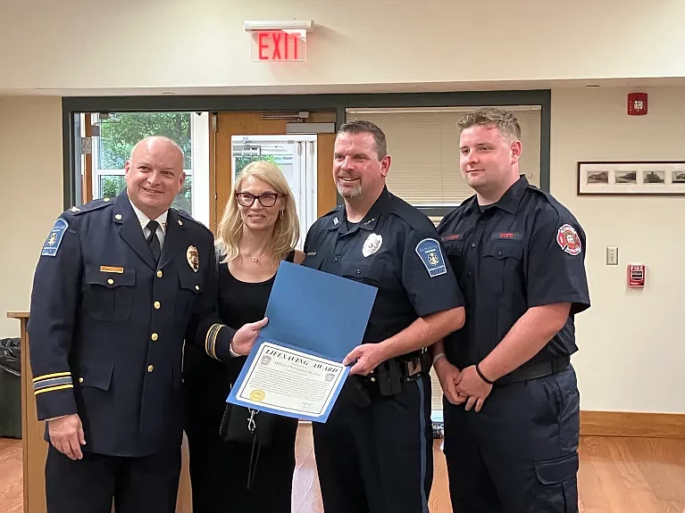 Towamencin police Chief Tim Troxel presents Officer Christopher McAroy, center, and Detective Christopher Bluem with lifesaving awards during the township supervisors’ June 26, 2024 meeting.