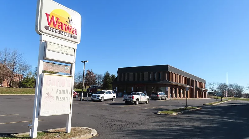 Faded signs stand in front of the current Wawa store at Forty Foot Road and Sumneytown Pike in Towamencin in December 2022.