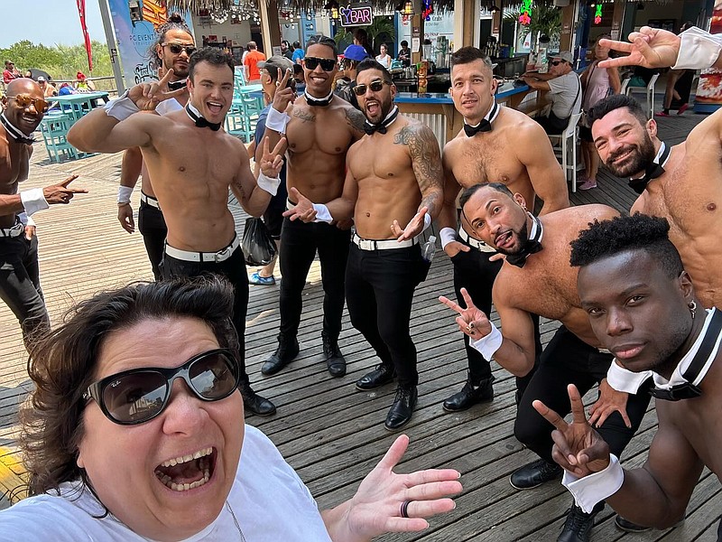 BreakingAC's Michelle Tomko poses with the Chippendales who took to the Boardwalk ahead of their appearance at Hard Rock.