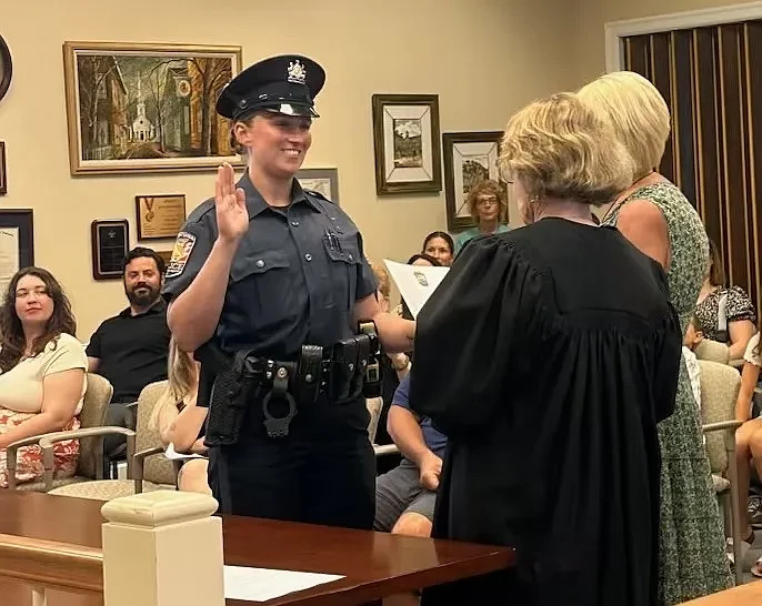 New Upper Gwynedd police Officer Amber Welsh receives her oath from district Judge Suzan Leonard during the township commissioners’ July 15, 2024 meeting.