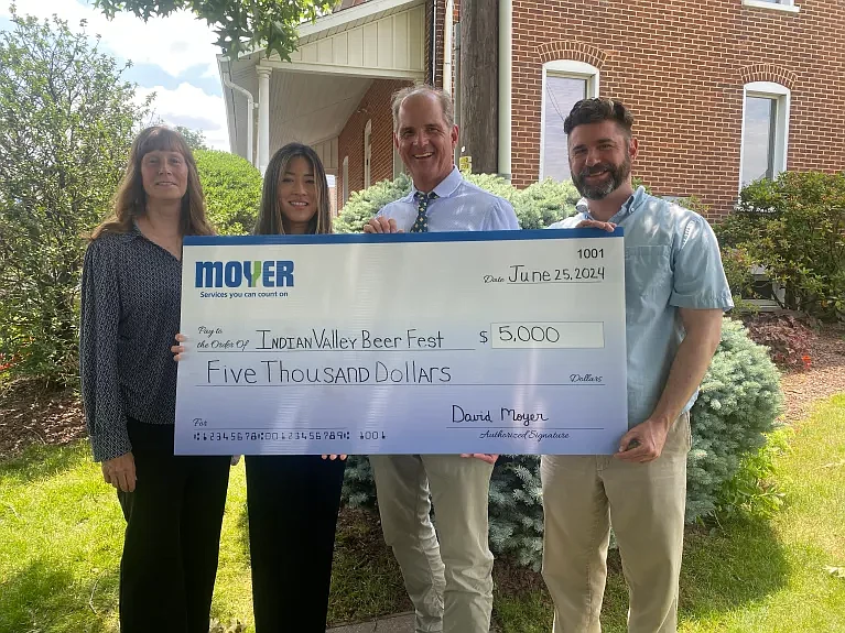 David and Amanda Moyer of Moyer present the $5,000 Premier Sponsor check to Kate Hoath of the Souderton-Telford Rotary Club and Nick Hagdorn of the Indian Valley Public Library.