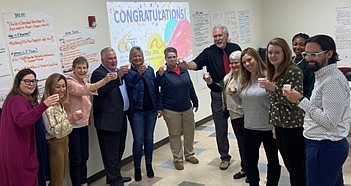 Pat Jones, COO (third from left) and Scott Hennis, CEO (fourth from left) join T The Arc of Atlantic County team members as they celebrate receiving The Council on Quality and Leadership's 2024 Person-Centered Excellence Accreditation.