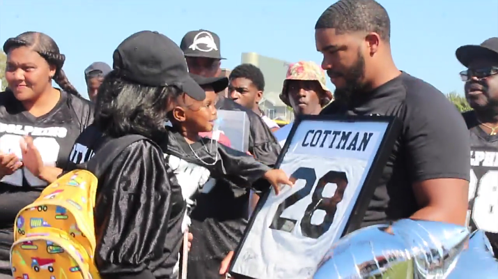 Demond Cottman's young son touches his late father's number.