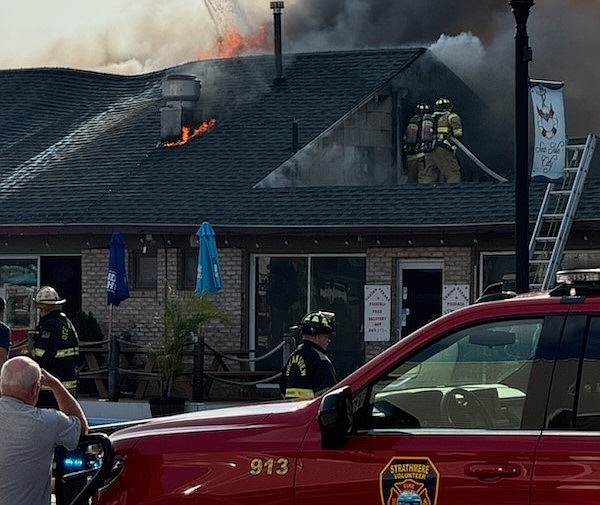 Flames shoot out of the top of the building on Park Road. (Photo courtesy of Melissa Doyle-Waid)