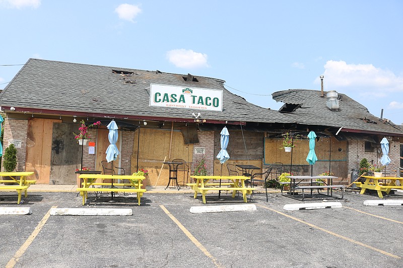 The building's collapsed roof is visible next to the Casa Taco sign.