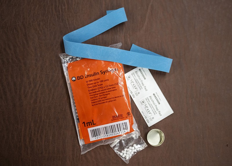 Syringes, alcohol swabs, and other supplies sit on a table in Western Pennsylvania. (Credit: Nate Smallwood / Spotlight PA)