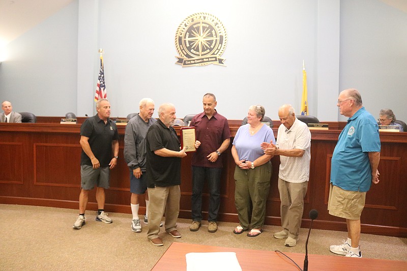 Mike Jargowsky, center, receives a commemorative plaque from Sea Isle City officials in recognition of his service as emergency management coordinator.