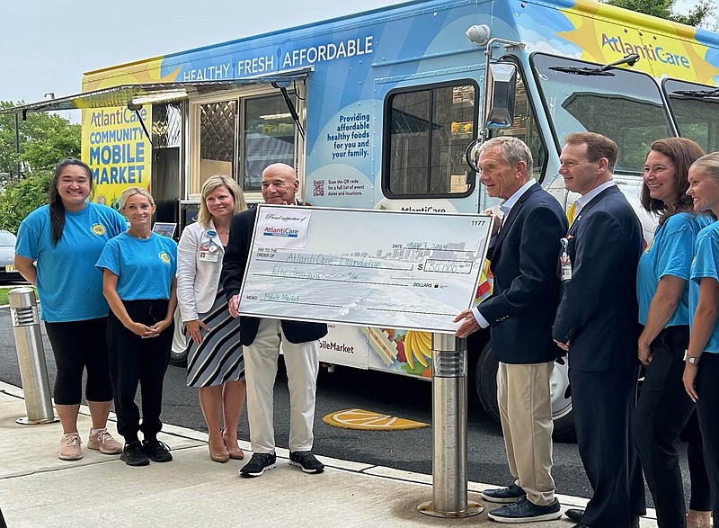 Donors former NJ Sen. William Gormley and attorney Lee Levine, present a check for $50,000 to the AtlantiCare Foundation. The donation will allow the foundation to expand offerings on the Community Mobile Market truck that brings healthy foods to underserved communities.