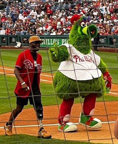 K-9 Officer Michael Braxton and the Phanatic after the pitch.