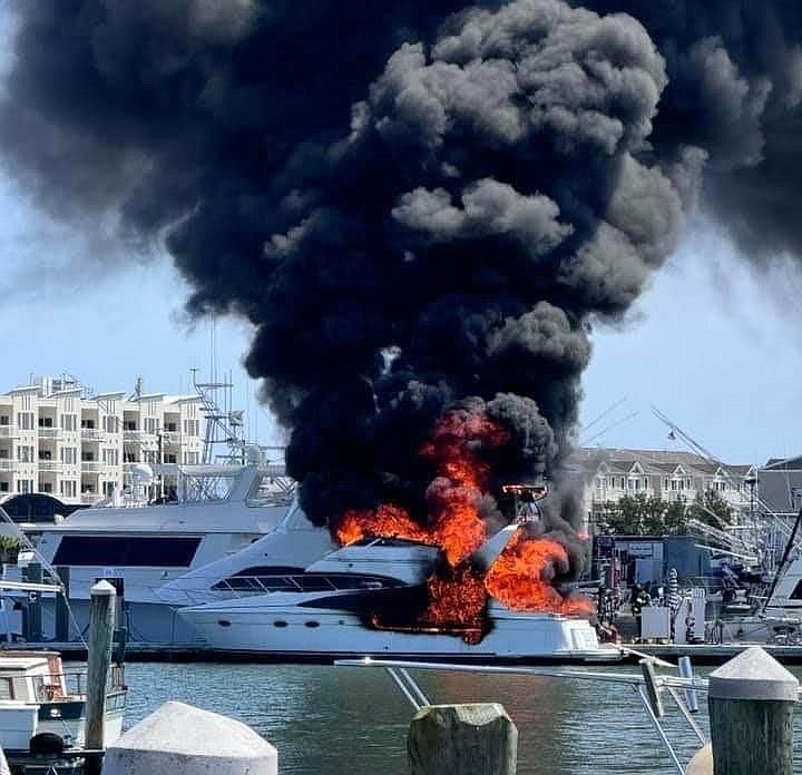 Flames and black smoke billow from the boat. (Photo credit: Urie's Waterfront Restaurant)