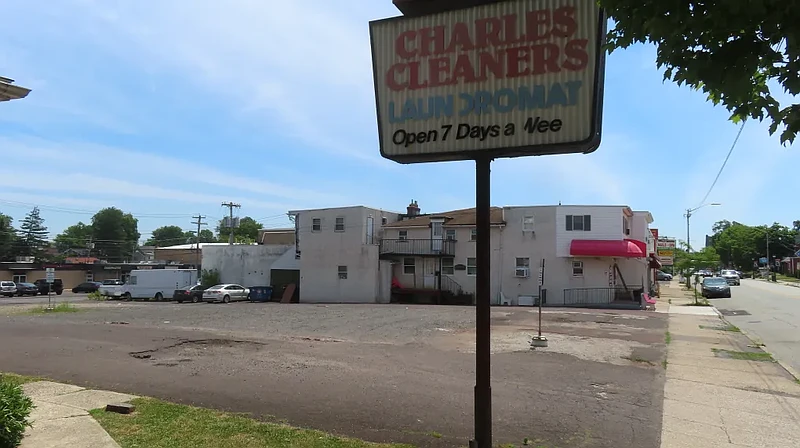 Cars drive by a vacant lot at 817 West Main Street in Lansdale, where a developer has proposed a new apartment and retail building, in June 2024.