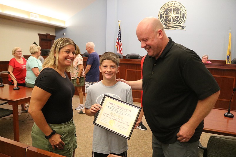 Aiden and his parents, Jen and Steve Beck, check out the proclamation declaring Aiden as Sea Isle City's "honorary mayor."