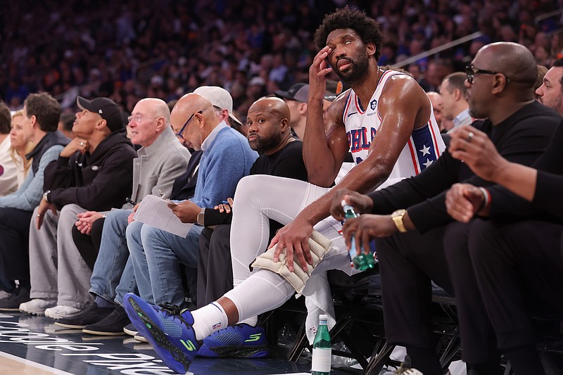 Apr 30, 2024; New York, New York, USA; Philadelphia 76ers center Joel Embiid (21) tends to his knee while sitting on the bench during the fourth quarter of game 5 of the first round of the 2024 NBA playoffs against the New York Knicks at Madison Square Garden. Mandatory Credit: Brad Penner-USA TODAY Sports