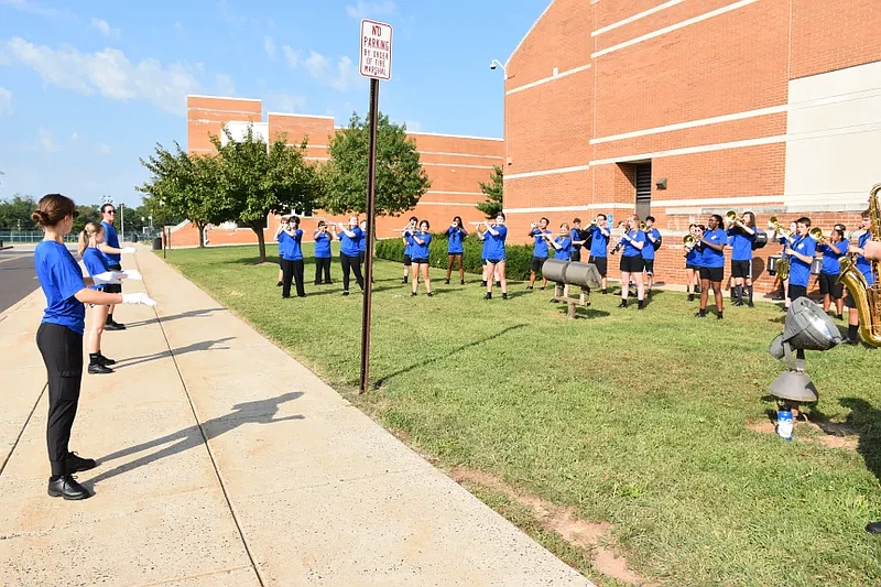 Members of the North Penn Marching Knights perform outside North Penn High School as staff return to school for the district’s convocation ceremony in Aug. 2024.