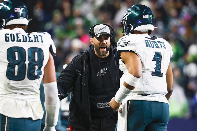 Dec 18, 2023; Seattle, Washington, USA; Philadelphia Eagles head coach Nick Sirianni greets quarterback Jalen Hurts (1) following a touchdown against the Seattle Seahawks during the third quarter at Lumen Field. Mandatory Credit: Joe Nicholson-USA TODAY Sports