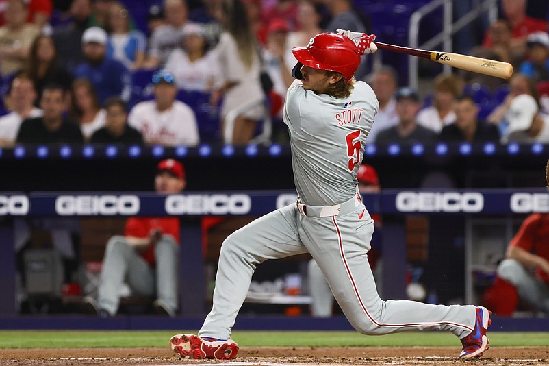 Sep 5, 2024; Miami, Florida, USA; Philadelphia Phillies second baseman Bryson Stott (5) hits a RBI single against the Miami Marlins during the first inning at loanDepot Park. Mandatory Credit: Sam Navarro-Imagn Images